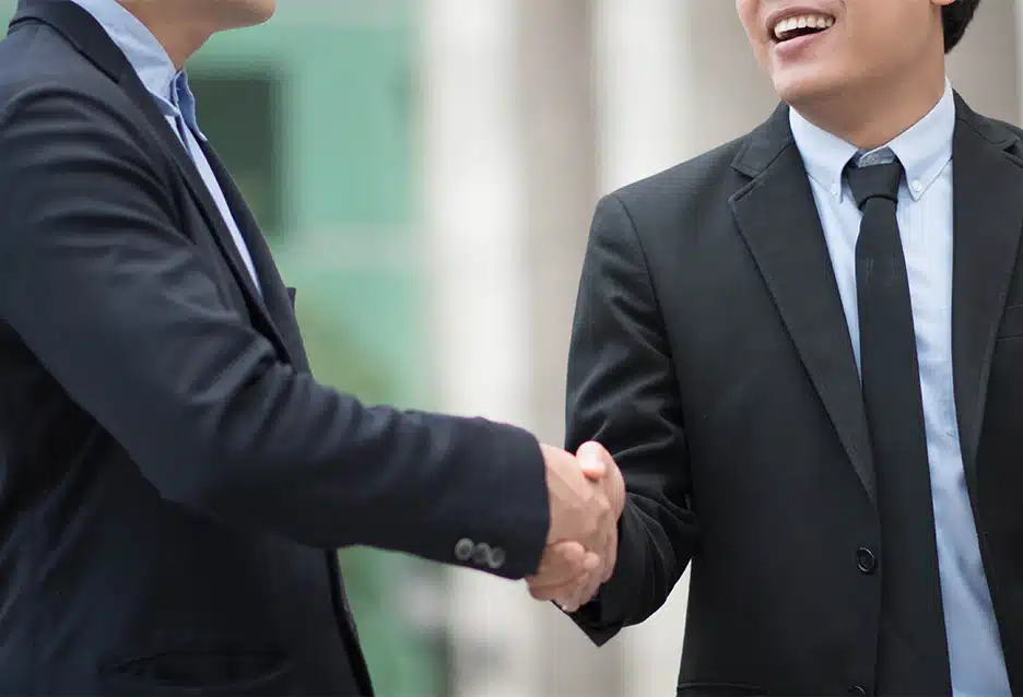 Two business professionals shaking hands