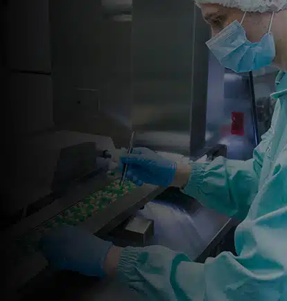 Man inspecting batch of pills for an Out of Specification (OOS) investigation in a factory