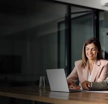 Two business professionals sharing a laptop to view a quality management system review